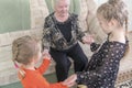 Great-grandmother plays with grandchildren in claps