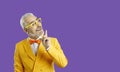 Great idea. Cheerful middle aged caucasian man pointing his finger up with inspiration, yellow background. Space for Royalty Free Stock Photo