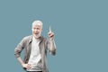 Great idea. Excited albino man pointing finger up, having aha moment over turquoise background with empty space Royalty Free Stock Photo