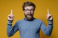 Great idea. Shaggy, bearded man with glasses and a blue sweater raises index fingers up and looks joyfully with mouth