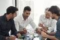 Great ideas in the making. a group of businessmen having a meeting around a table in an office. Royalty Free Stock Photo