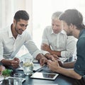 Great ideas in the making. a group of businessmen having a meeting around a table in an office. Royalty Free Stock Photo