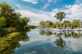 Great inviting landscape view with yachts and boats floating, parked in center island on sunny day