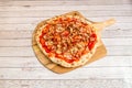 Great Italian chef preparation of thin-crust pizza with barbecue sauce with chopped fried chicken, ham slices stewed minced