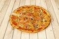 Great Italian family pizza with whimsical recipe with ham, tomato, oregano, mushrooms