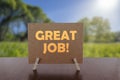 Great job text on card on the table with sunny green park background Royalty Free Stock Photo