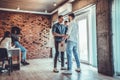 Two men handshake to seal deal, cheerful partners greeting each other in loft office Royalty Free Stock Photo