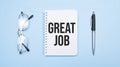 Great Job words in white notepad, pen and glasses on blue background. Concept Royalty Free Stock Photo