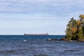 Great Lakes Freighter Passing Behind a Rocky Island Royalty Free Stock Photo