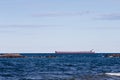 Great Lakes Freighter Passing Behind Rocky Outcroppings Royalty Free Stock Photo