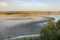 Great landscape with dry cracked earth lake shore and blue sky. Drought terrain. Unusual fantastic landscape. Royalty Free Stock Photo