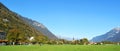 Interlaken, Switzerland, Mountains, houses and huge lawn yard field Royalty Free Stock Photo