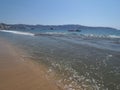 Great landscape of sandy beach at bay of ACAPULCO city in Mexico with motor boat and waves of Pacific Ocean Royalty Free Stock Photo