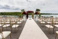 Great location for the outdoor ceremony on the pontoon by the water. Chairs and flower arrangement for the ceremony. Royalty Free Stock Photo