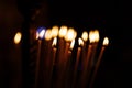 Great long Candles in a church with dark background. burning candles in church on dark background Royalty Free Stock Photo