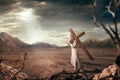 Great martyr with cross in desert, sun rays Royalty Free Stock Photo