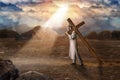 Great martyr with cross in desert, sun rays Royalty Free Stock Photo