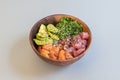 Great mixed poke bowl of marinated salmon and red tuna with ripe avocado, wakame seaweed salad, base white rice Royalty Free Stock Photo