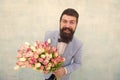 In great mood. bride groom at wedding party. bearded man in bow tie with tulip flowers. love date with flowers. Happy Royalty Free Stock Photo