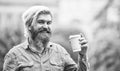 Great morning meal. Coffee on the go. man with a cup of coffee outdoors. Handsome calm bearded man outdoors with a cup