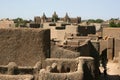 The great mosque emerges over the rooftops of Djenne, Mali Royalty Free Stock Photo