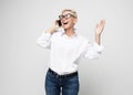 Great news. Modern Communication. Happy senior woman using mobile phone over grey background. Royalty Free Stock Photo