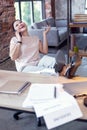 Exuberant female employee dangling on phone