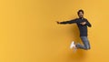 Great Offer. Excited indian man pointing aside while jumping up in air Royalty Free Stock Photo