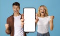 Great Offer. Excited Young Couple Showing Blank Smartphone And Raising Fists Royalty Free Stock Photo