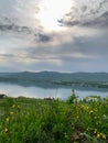 Great panoramic view. A clean mountain lake in the midst of majestic mountains in a haze of fog. On the Sunset. Copy Royalty Free Stock Photo