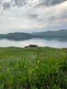 Great panoramic view. A clean mountain lake in the midst of majestic mountains in a haze of fog. On the Sunset. Copy Royalty Free Stock Photo