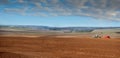 panoramic view of Farmers plowded land , tractor with a seeder, sowing time at spring Royalty Free Stock Photo
