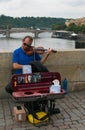 Great performance of street musician of violinist on Charles Bridge, Prague