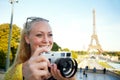 This is a great photo opportunity. A beautiful young woman taking photos while sight seeing in the Paris. Royalty Free Stock Photo