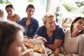 The great pizza get-together. a group of friends enjoying pizza together.