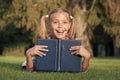 Great place to read. Happy small child read library book outdoor. Adorable little girl learning to read at primary Royalty Free Stock Photo