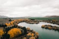 great plain showing the different shades of the leaves of the trees in autumn on the shore of the small lake with a Royalty Free Stock Photo