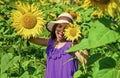 Great plants. yellow flower of sunflower. happy childhood. beautiful girl wear straw summer hat in field. pretty kid Royalty Free Stock Photo