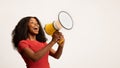 Great Promo. Excited Black Lady Using Megaphone For Making Announcement Royalty Free Stock Photo