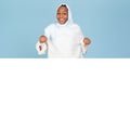 Great promo. Happy black muslim woman pointing down at copy space on blank white advertisement board, mockup Royalty Free Stock Photo