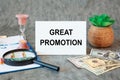 Great Promotion is written in a document on the office desk, money and diagram