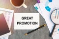 Great Promotion is written in a document on the office desk, coffee, diagram and smartfon