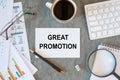 Great Promotion is written in a document on the office desk, diagram and keyboard