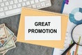 Great Promotion is written in a document on the office desk, money and keyboard