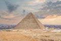 The great pyramid of Cheops in Cairo. The Egyptian pyramids of Giza on the background of Cairo. Miracle of light. Architectural Royalty Free Stock Photo