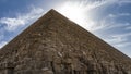 The Great Pyramid of Cheops in Giza. A triangular peak on a background of blue sky