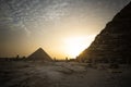 great pyramid of Mikerina and pyramid of cheops in Cairo, Egypt. Pyramids of Menkaura against blue cloudy sky in the evening at a Royalty Free Stock Photo