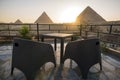 Great Pyramids of Chephren Khafra and Cheops Khufu and Mikerina Menkaura. Sunset on Giza plateau. sun sets below horizon. rooftop Royalty Free Stock Photo