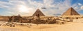 The Great Pyramids of Giza and The Sphinx near the ruins of a temple in Giza, Egypt