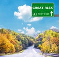 GREAT RISK road sign against clear blue sky Royalty Free Stock Photo